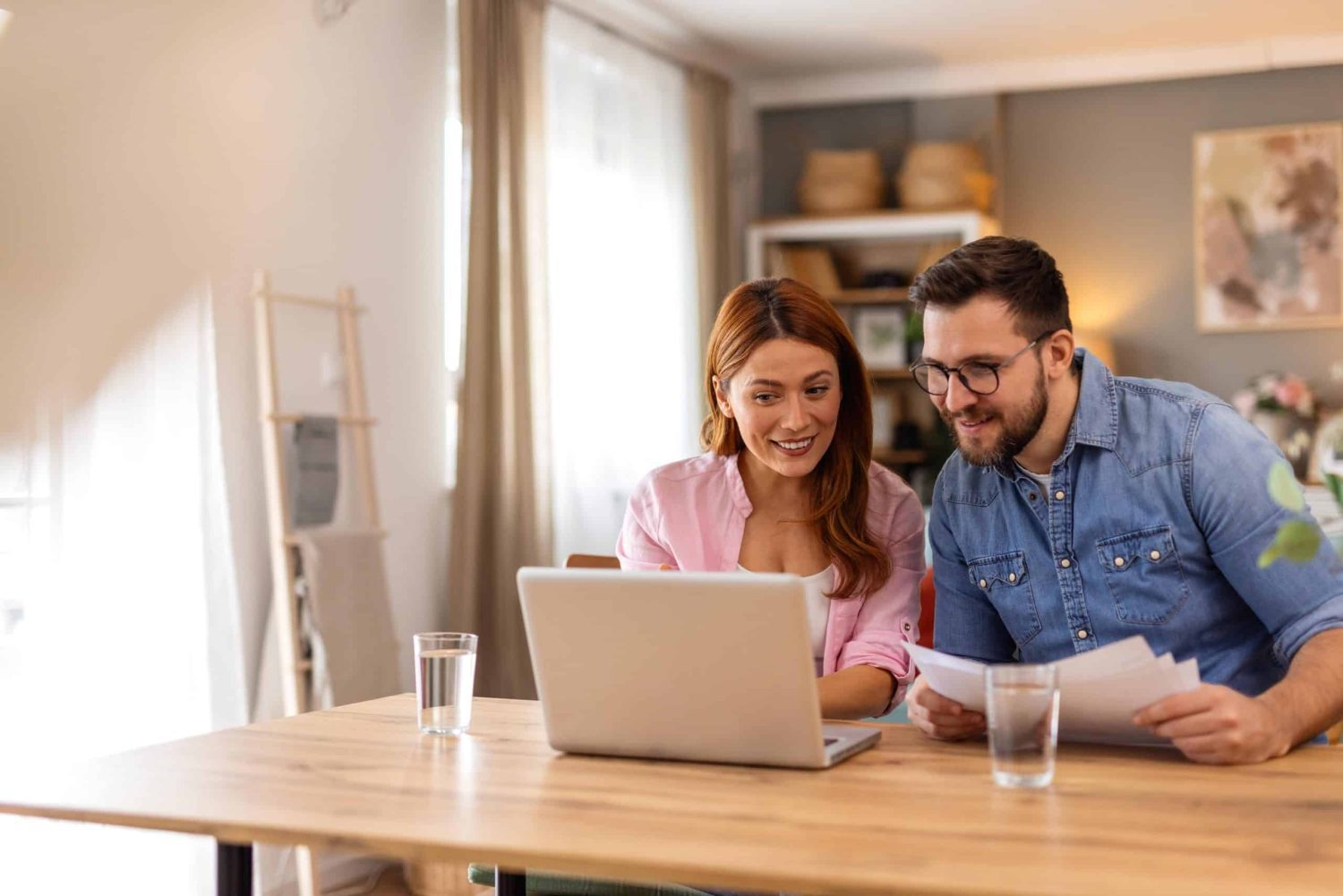 Smiling Couple Collaborates On Financial Planning